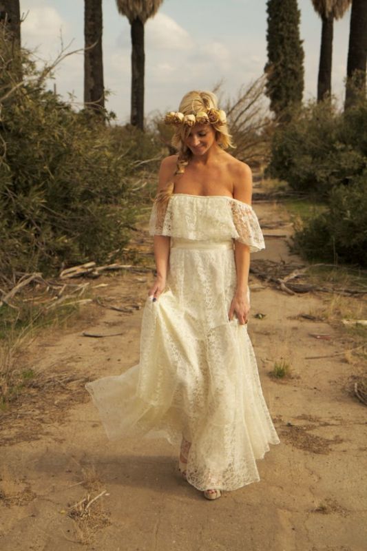 A bride wearing a hippie bohemian wedding dress on the beach