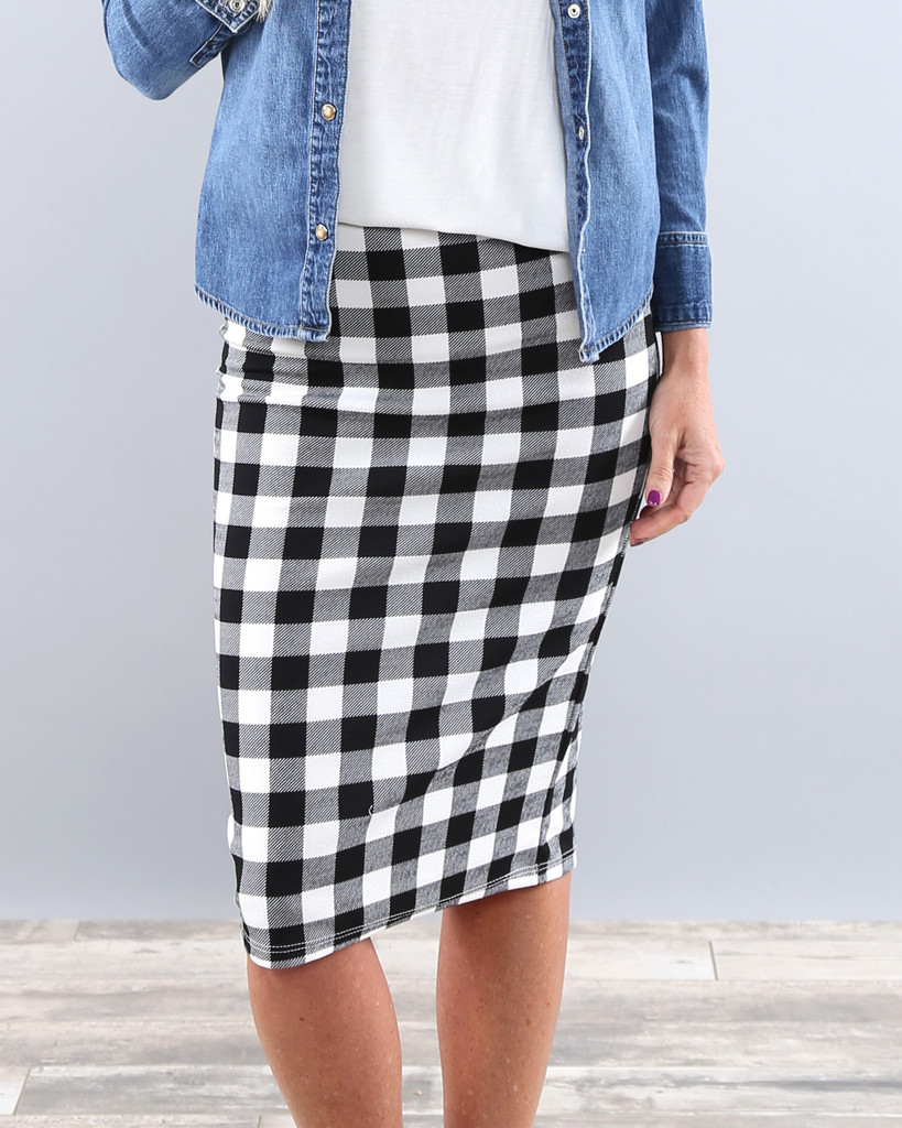 White and black pencil skirt The skirt is made in a stretch, matt (not shiny) black and white jersey fabric. The skirt sits at the base of the knee and there is a split shaped like a V on the front that can be seen with zoom, so the skirt opens slightly at the knee.